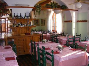 a dining room with tables and chairs with pink tablecloths at Luci del Golfo in Alghero