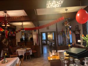 a dining room with tables and chairs and red balloons at Pension Restaurant Ewald in Bischofsheim an der Rhön