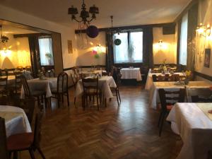 a dining room with tables and chairs and white tables at Pension Restaurant Ewald in Bischofsheim an der Rhön