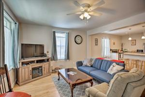 a living room with a blue couch and a tv at Family-Friendly Menomonie Retreat Walk to Town! in Menomonie