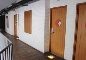 a hallway with doors and a clock on the wall at MaxOneHotels.com at Sabang in Jakarta