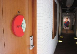 a door with a red sign on the side of a hallway at MaxOneHotels.com at Sabang in Jakarta