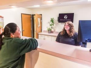 a woman standing in front of a hotel mirror at Hotel 7 Inn Vienna in Vienna