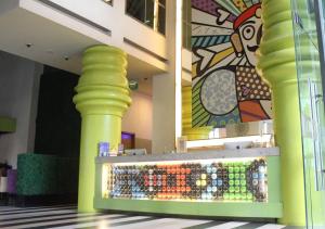 a store with yellow columns and a display of colored bottles at MaxOneHotels.com at Sabang in Jakarta