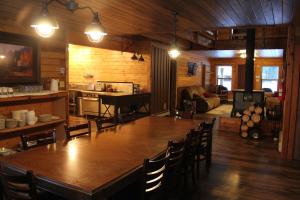 a large wooden table and chairs in a room at Sugar Loaf Lodge & Cabins in Anaconda