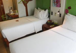 two beds sitting next to each other in a room at MaxOneHotels.com at Sabang in Jakarta