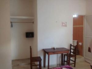 a small room with a table and two chairs at Posada Olmeca in Playa del Carmen