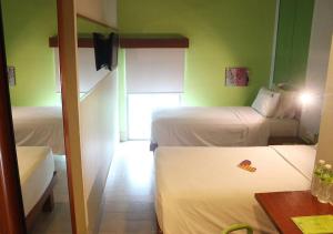a hotel room with two beds and a table and a room at MaxOneHotels.com at Sabang in Jakarta