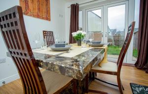 a dining room with a marble table and chairs at Somerset Place in Northampton