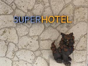a statue of a squirrel sitting on a stone wall at Super Hotel Naha Shintoshin in Naha
