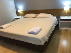 a bedroom with a large bed with towels on it at Regency Bombal Apartments in Mendoza