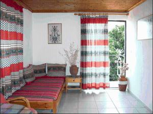 a living room with a couch and a window at Kyra's Paradise in Potistika