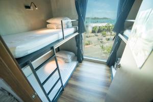 Tempat tidur dalam kamar di Homy Seafront Hostel