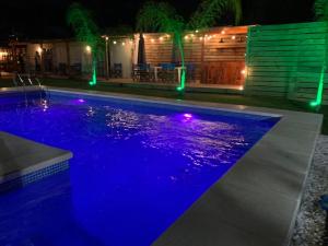 una piscina por la noche con luces azules en La Posada de la Pedrera, en La Pedrera