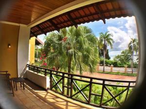 a balcony with a view of a palm tree at Tiara Labuan Hotel in Labuan