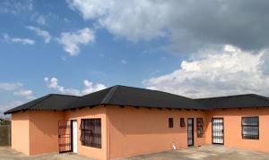 a building with a black roof on top of it at Mankweng lodge in Polokwane