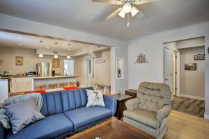 a living room with a blue couch and a chair at Family-Friendly Menomonie Retreat Walk to Town! in Menomonie