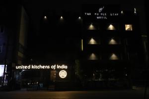 a building with the words united kitchens of india at night at The Purple Leaf Hotels in Hyderabad