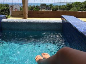 a person laying down in a swimming pool at Kenting Nanwan AlohaInn in Nanwan