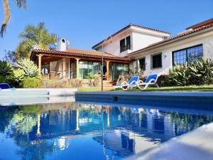a house with a swimming pool in front of a house at Nanou House in La Matanza de Acentejo