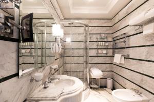 a bathroom with a sink and a mirror at La Ciliegina Lifestyle Hotel in Naples +37 photos