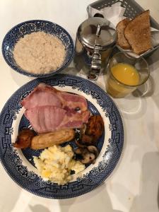 a plate of food with meat and rice and bread at Park Guest House in Inverness