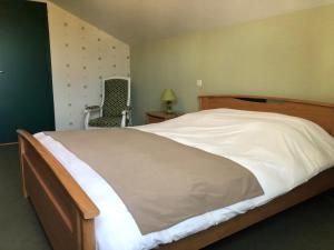 Katil atau katil-katil dalam bilik di Maison d'hôtes La Colombelle