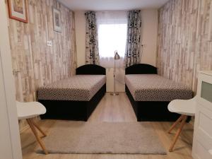 Postel nebo postele na pokoji v ubytování Tabán Apartman