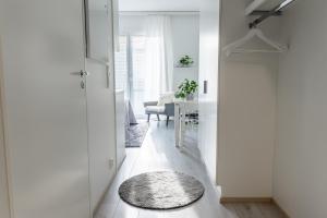 a hallway with a dining room with a table at Compact high quality top floor studio in perfect location in Oulu