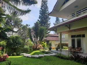 a view of a house with a garden at Villa Bougenvile Lembang Asri in Lembang