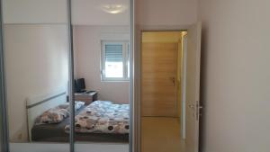 ポドゴリツァにあるGuest House Mikeli (BESPL. DORUCAK)-(FREE BREAKFAST)の鏡付きのベッドルーム1室、ベッド1台が備わるベッドルーム1室を提供しています。
