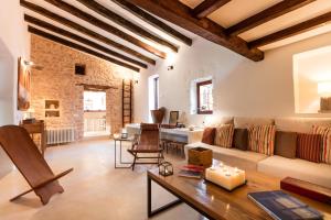a living room with a couch and a table at Villa Can Toni Mateu in Sant Francesc Xavier