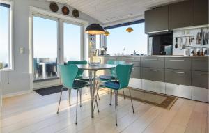 a kitchen with a table and green chairs at Nice Home In Esbjerg V With Wifi in Esbjerg