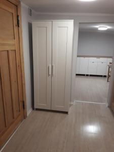 an empty room with a white closet and a door at Apartament Mariacka Two in Bydgoszcz