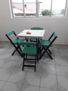 a table and chairs with a laptop on it at Pousada Bela Vista in Castro