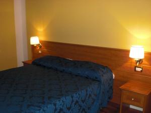 Postel nebo postele na pokoji v ubytování Hotel Palazzo Bruni