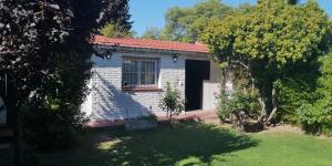 a small white brick house with a window at Disfruta como local in Mendoza
