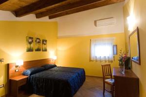 Postel nebo postele na pokoji v ubytování Hotel Palazzo Bruni