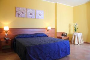 Postel nebo postele na pokoji v ubytování Hotel Palazzo Bruni