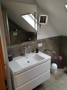 a bathroom with a sink and a mirror at Ferienwohnung "Deluxe" in Korbach in Korbach