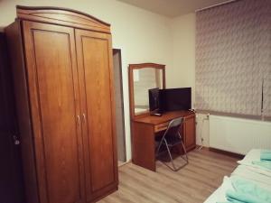 a bedroom with a desk with a computer and a mirror at Guest House Nani in Asenovgrad