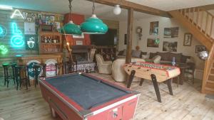 a living room with a pool table and a bar at La Ferme Oasis in Belloy