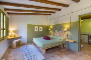 a bedroom with a bed and two tables and a window at Lananai eco-ospitalità in San Vito