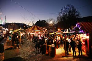 a crowd of people walking around a christmas market at Chalet Les Camélias SPA in Gérardmer