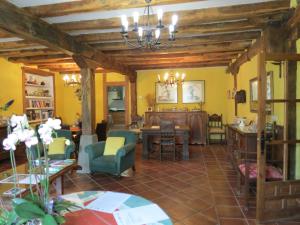 a living room with yellow walls and wooden ceilings at Herranetxe in Bóveda