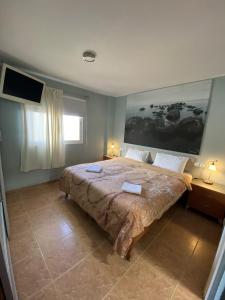 a bedroom with a large bed with two towels on it at Casa Candelaria in Candelaria