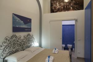 a hotel room with a bed, table, and window at Affittacamere del Golfo e delle 5 Terre in La Spezia