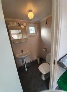 a small bathroom with a toilet and a sink at Maren 1 in Mörlunda