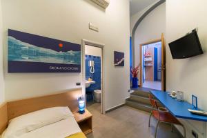 a hotel room with a bed, desk and a computer at Affittacamere del Golfo e delle 5 Terre in La Spezia