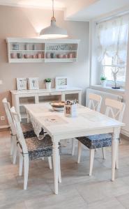 a dining room with a white table and chairs at Ferienwohnung Fanny in Dresden